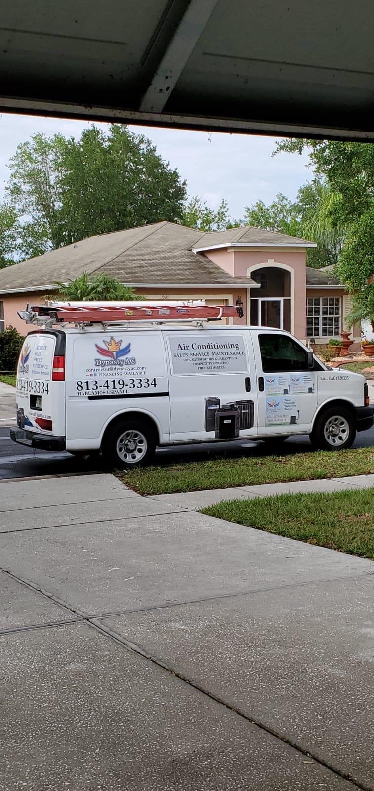 Dynasty AC service van outside a customer home