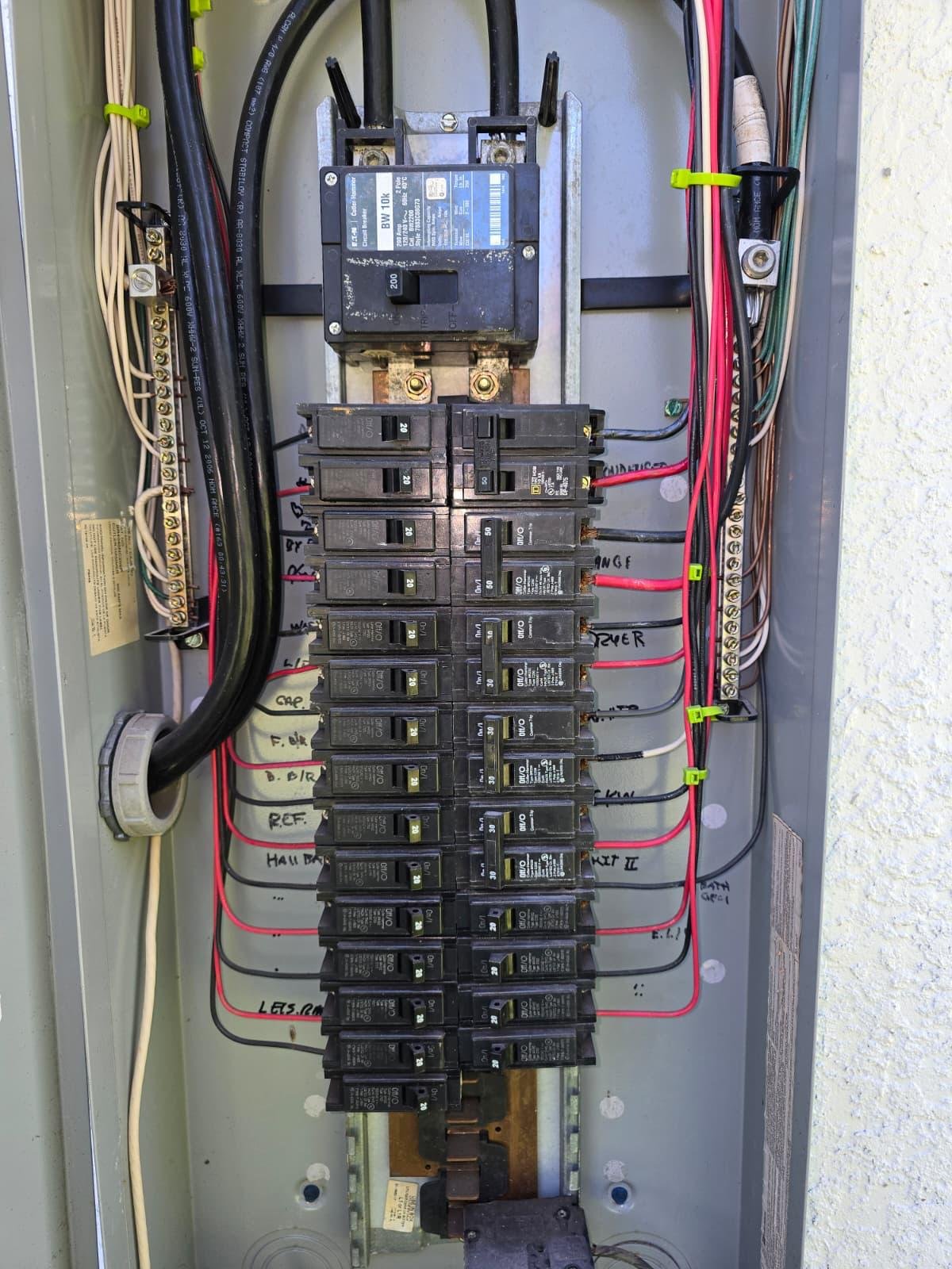 Open electrical panel with 200-amp main breaker and labeled branch circuits