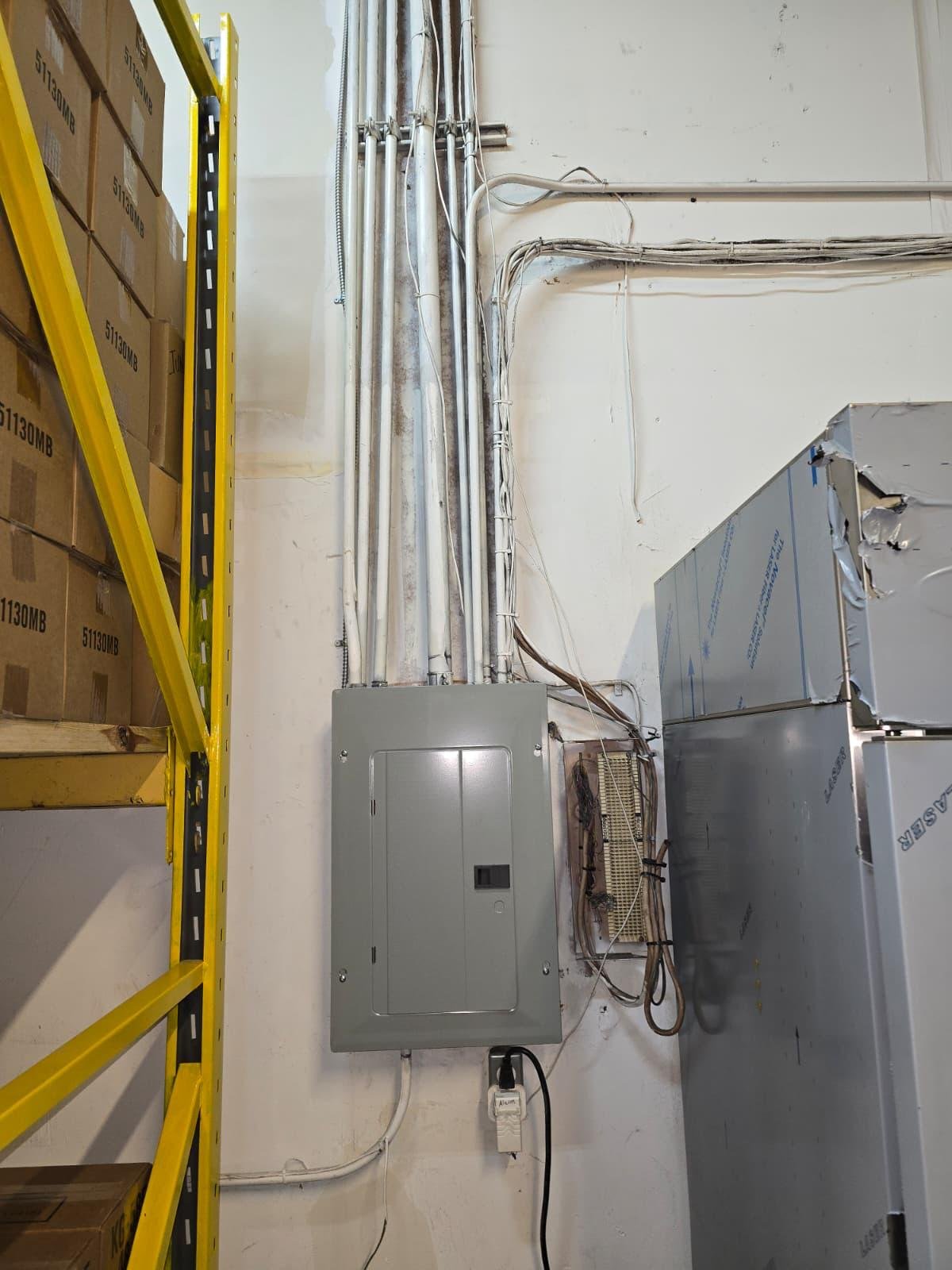 Electrical sub-panel and conduit wiring installed near insulated ductwork