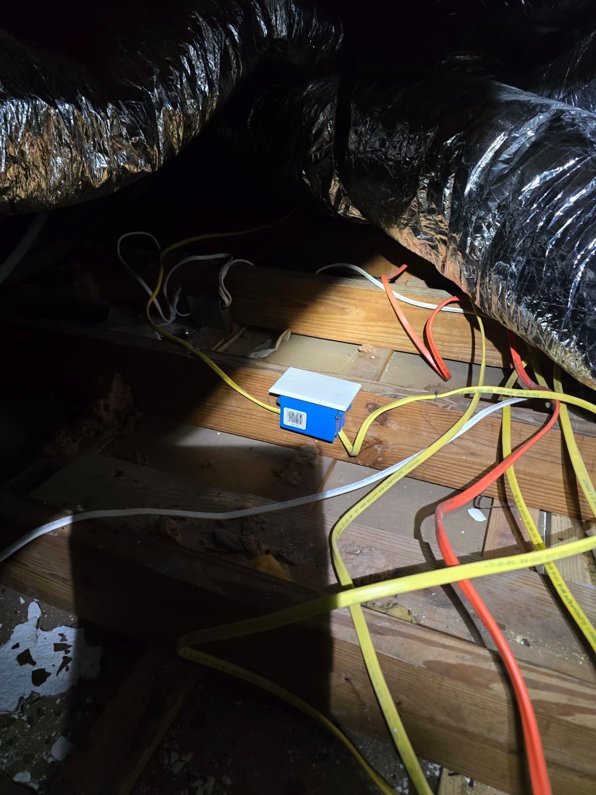 Electrical wiring and junction box installed among insulated ductwork in an attic