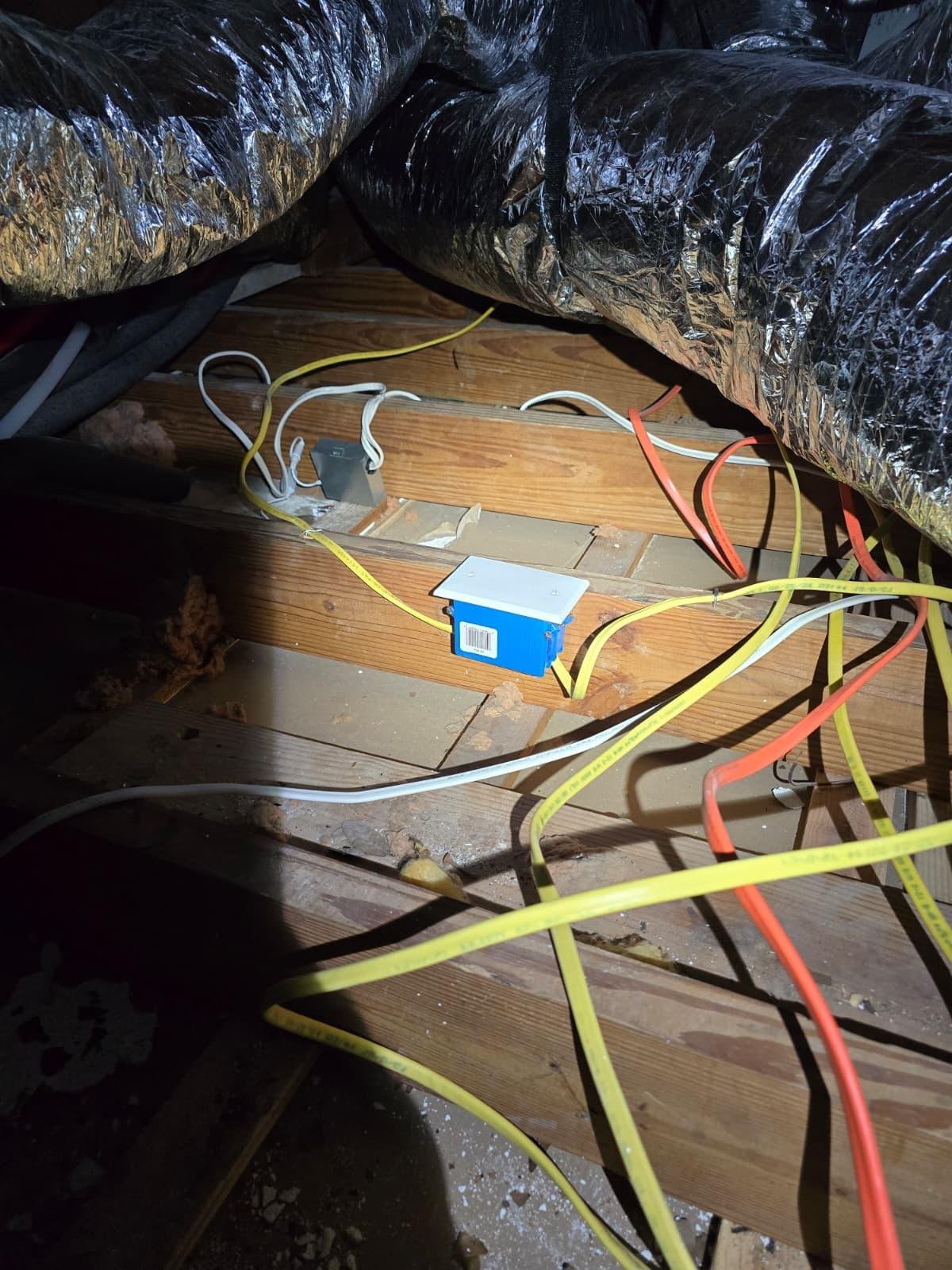 Electrical wiring and junction boxes installed near attic floor joists and ductwork