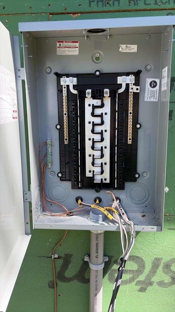 Open electrical panel showing bus bars and wiring during installation