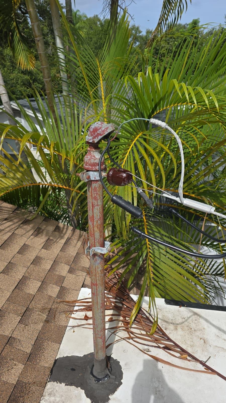 Electrical service mast and weatherhead installed on a rooftop