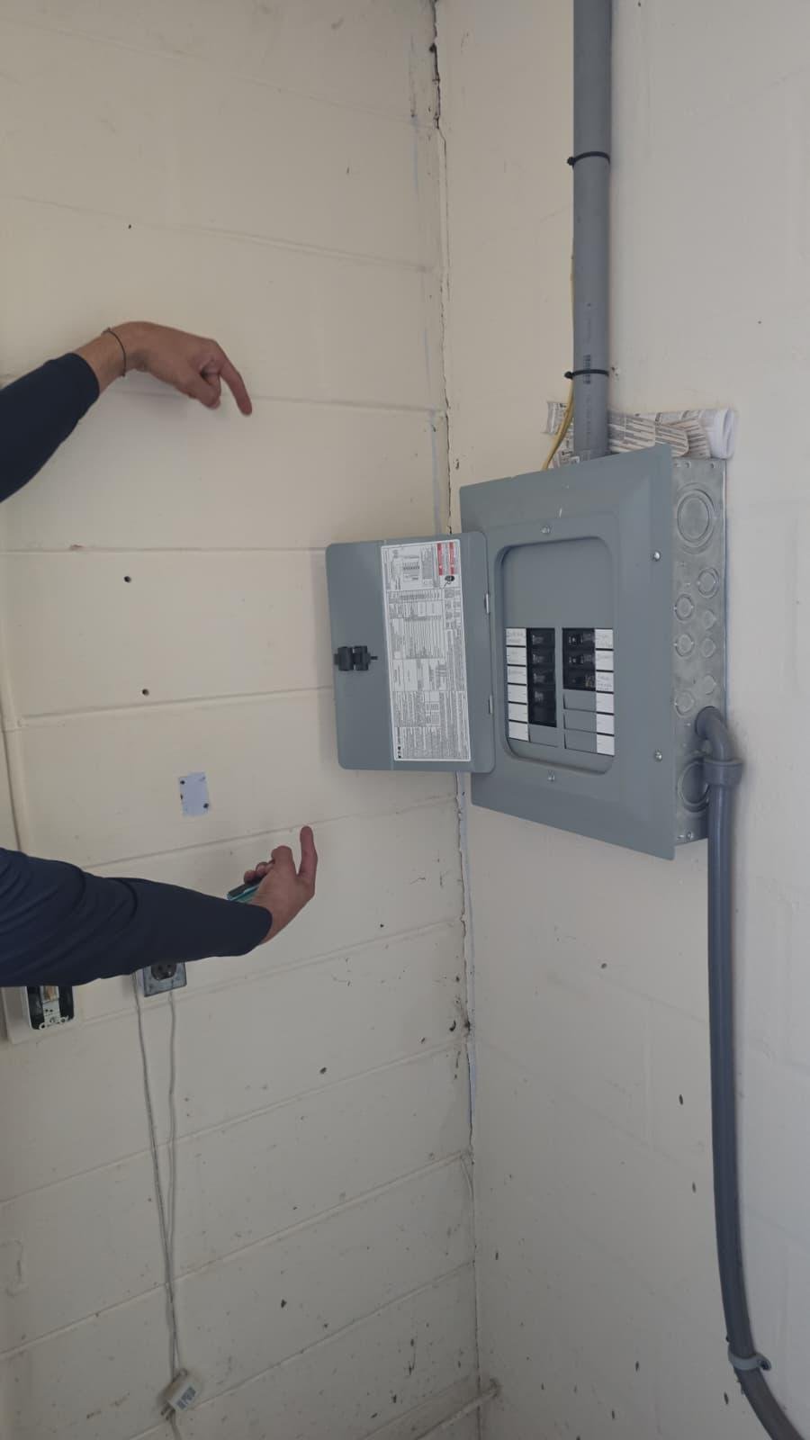 Electrical panel installed on interior block wall with conduit wiring