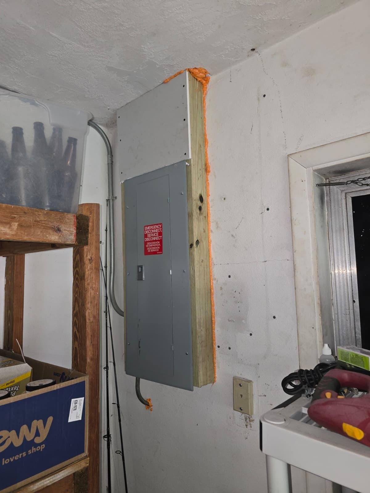 Electrical panel newly installed on a mounting board in a garage